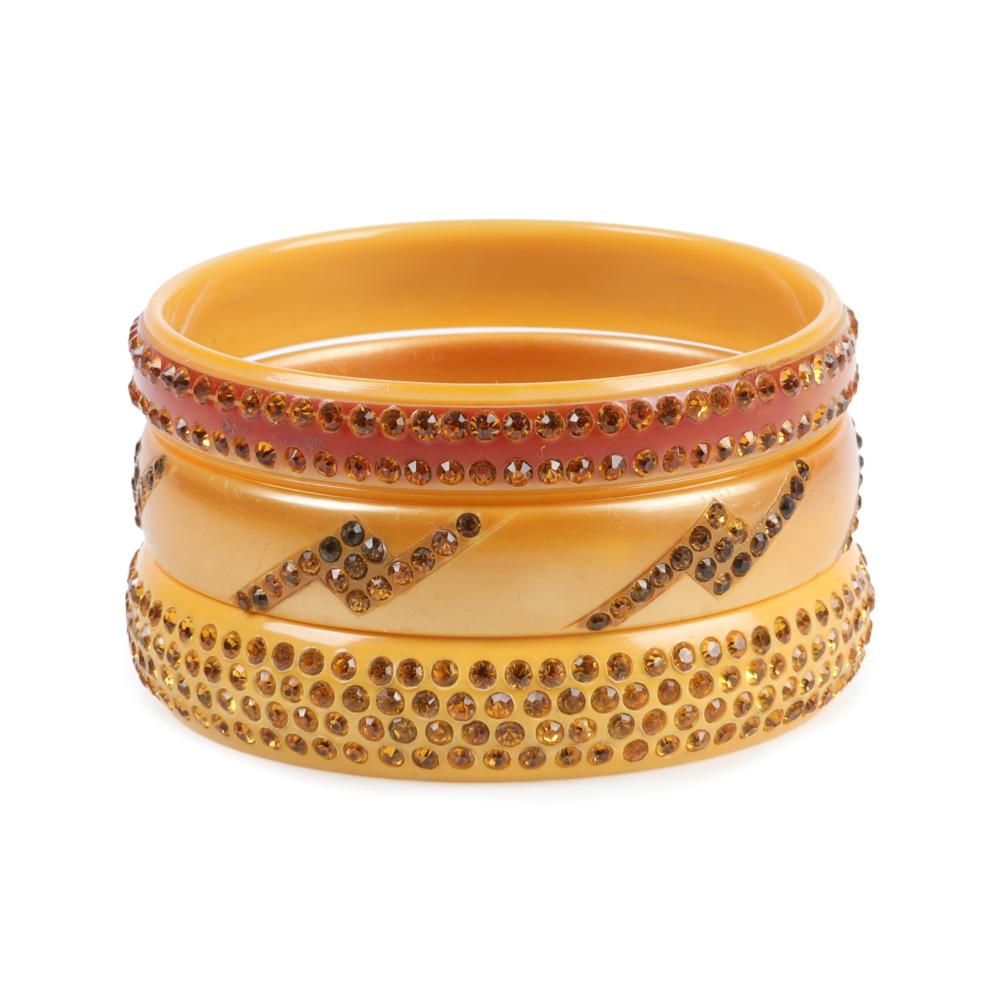 Appraisal: THREE CREAMY GOLD CELLULOID SPARKLER BANGLE BRACELETS INNER DIAM WThree