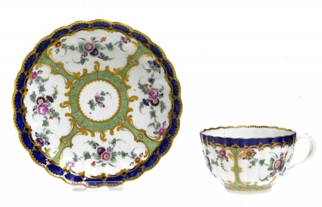 Appraisal: A WORCESTER FLUTED TEA CUP AND SAUCER painted to the