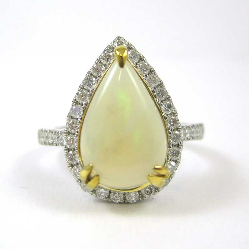 Appraisal: OPAL DIAMOND AND FOURTEEN KARAT GOLD RING The white and