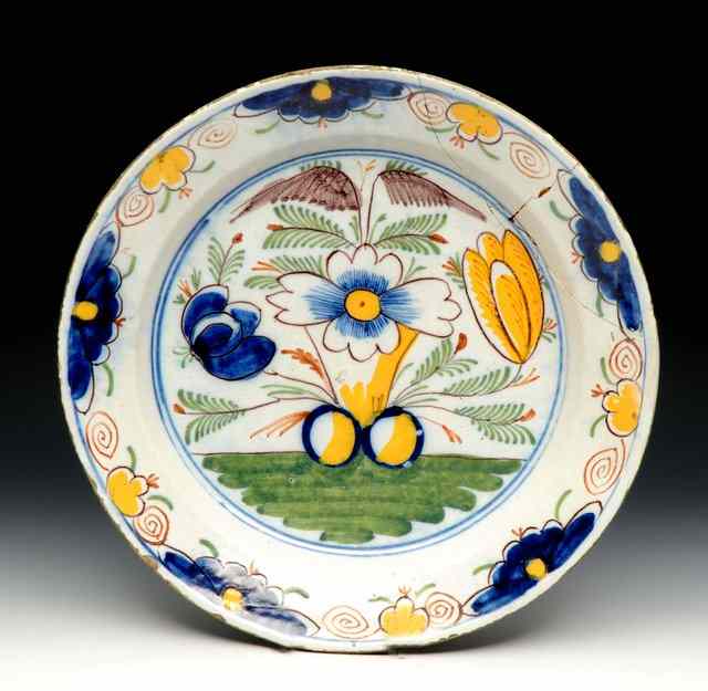 Appraisal: AN ANTIQUE DELFT CIRCULAR DISH with polychrome floral decoration diameter