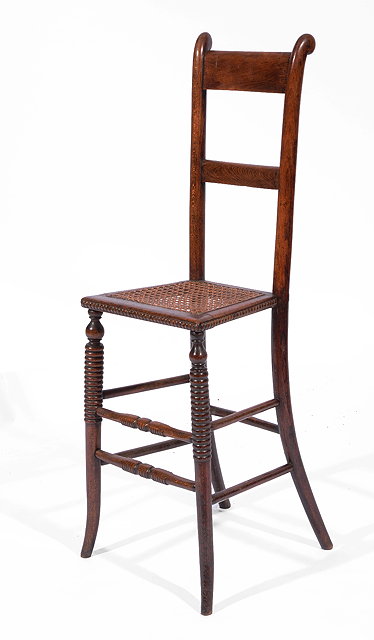 Appraisal: A VICTORIAN BEECH WOOD CHILD'S CORRECTION CHAIR with cane seat