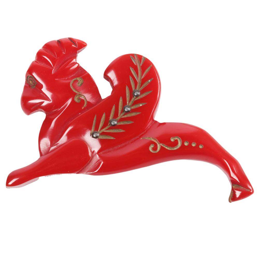 Appraisal: BAKELITE RED CARVED AND GOLD PAINTED GRYPHON MOGUL PIN H