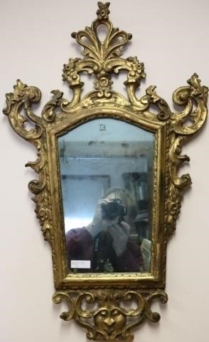 Appraisal: TH C ITALIAN LOOKING GLASS WITH A N ORNATECARVED AND