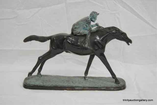 Appraisal: Cast Bronze Racing Horse Rider StatueFrom the estate is a