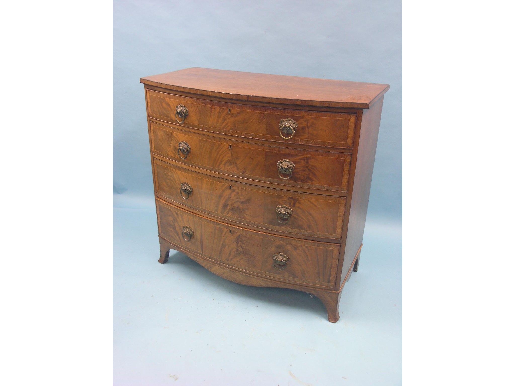 Appraisal: A late Georgian bow-fronted mahogany chest four graduated drawers with