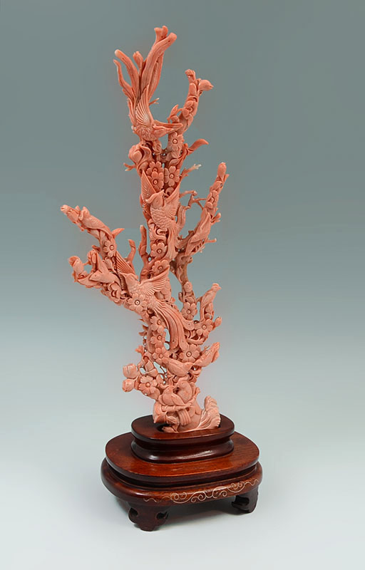 Appraisal: CARVED CORAL FIGURAL BIRDS OF PARADISE IN TREE Approx birds