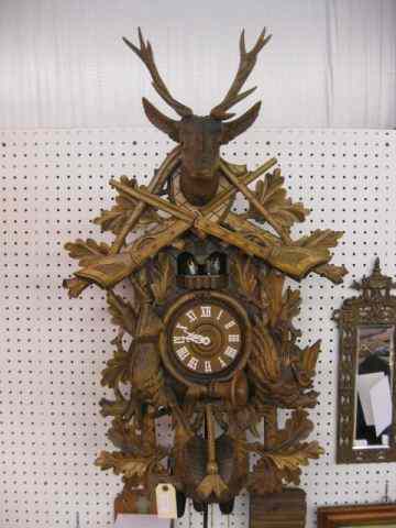 Appraisal: Black Forest Carved Wooden CooCoo Clock '' Hunter model rifle