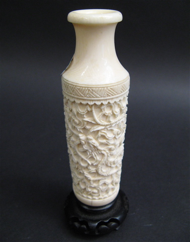 Appraisal: CHINESE IVORY BUD VASE having intricate carved dragon decoration attached