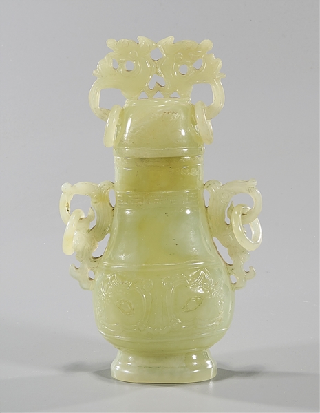 Appraisal: Chinese carved jade covered vase depicting mask faces with beast