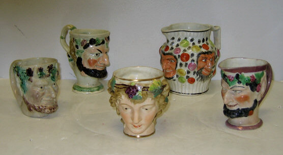 Appraisal: FIVE PEARLWARE MASK JUGS AND MUGS Four molded as heads