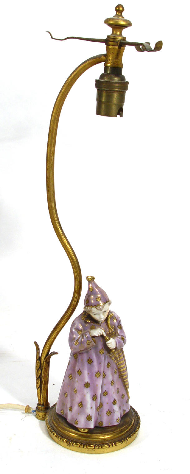 Appraisal: Gilt metal table lamp mounted with a Continental porcelain figure