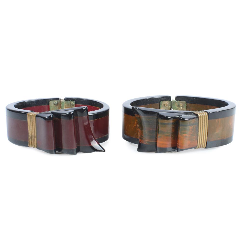 Appraisal: TWO BAKELITE 'S RIBBON HINGED CLAMPER CUFF BRACELETS WITH BRASS