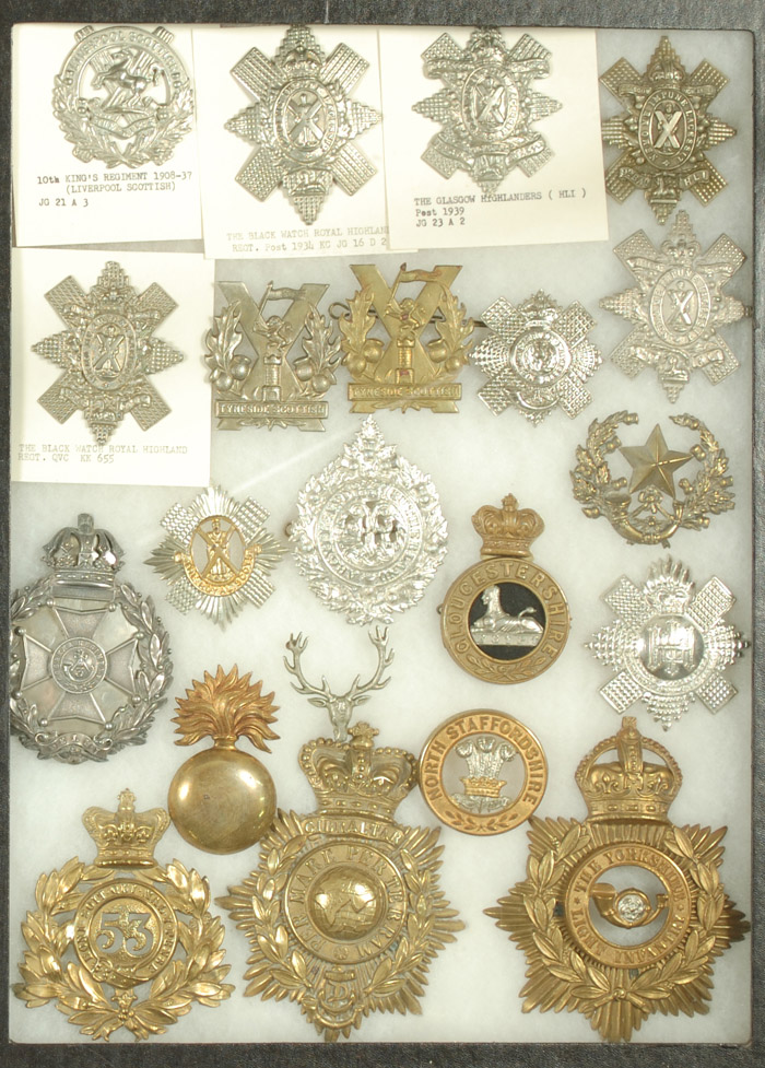 Appraisal: COLLECTION OF TWENTY TWO HELMET BADGES including rd Gookkha Regt