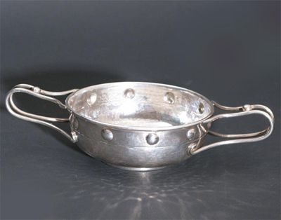 Appraisal: An A E Jones silver twin-handled porringer wirework handles with