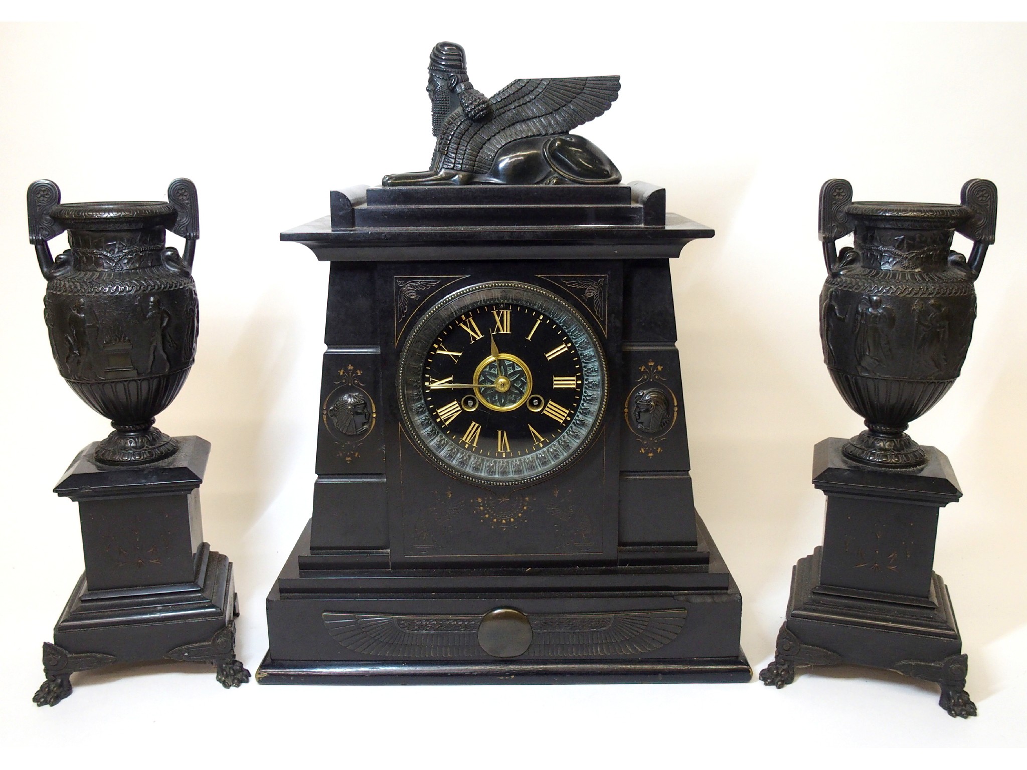 Appraisal: A Victorian black slate Egyptian taste composite clockwith Assyrian winged