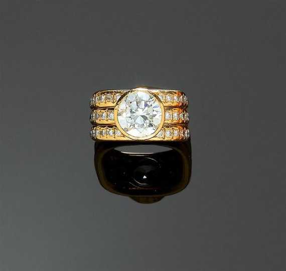 Appraisal: DIAMOND RING TRUDEL Yellow gold Casual-elegant band ring with a