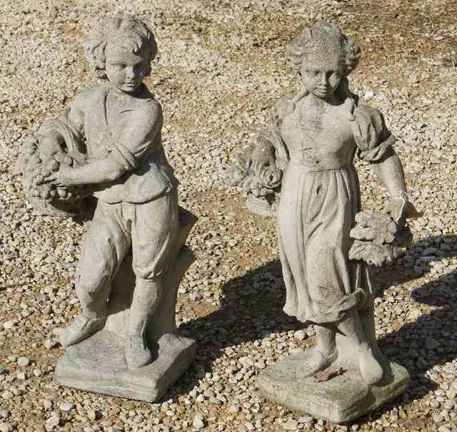 Appraisal: A PAIR OF COMPOSITE STONE FIGURES of a girl and