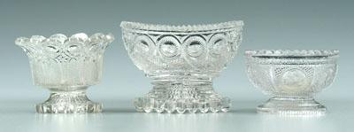 Appraisal: Three Sandwich glass salts clear pedestal type one circular with