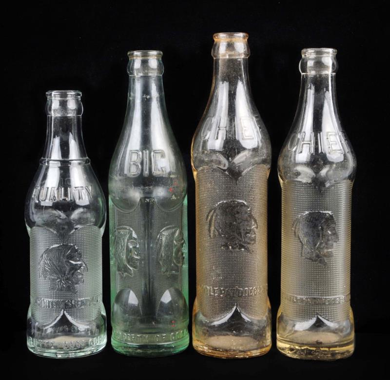 Appraisal: Lot Of Big Chief Embossed Soda Bottles These four Big