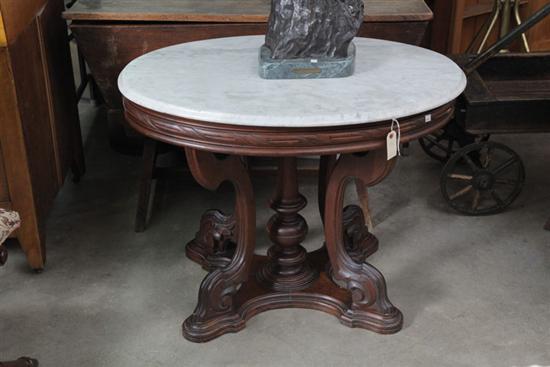 Appraisal: VICTORIAN WALNUT MARBLE TOP PARLOR TABLE Having a striated dark