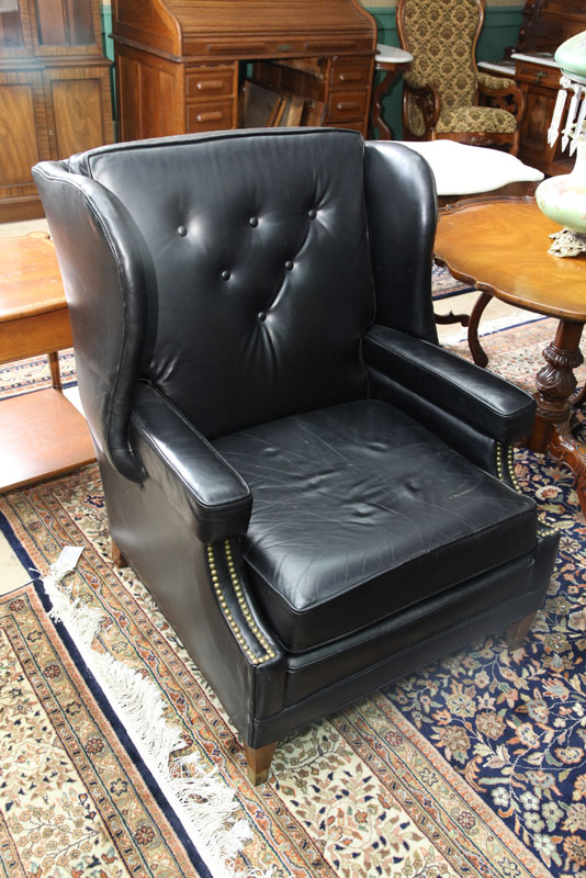 Appraisal: LEATHER ARMCHAIR Black leather wing and button back '' h