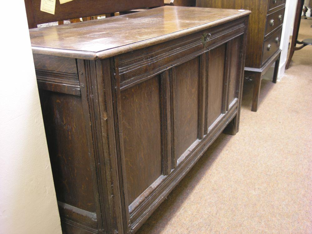 Appraisal: An th century oak coffer with panelled front ft in