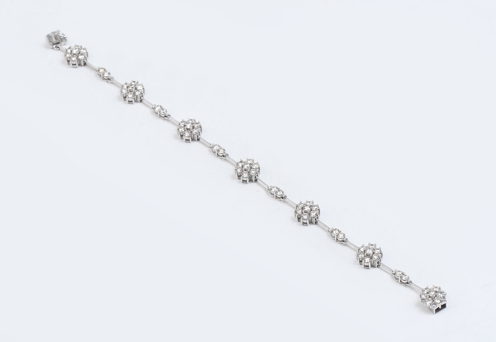 Appraisal: K DIAMOND FLOWER BRACELET prong set diamonds form flower stations