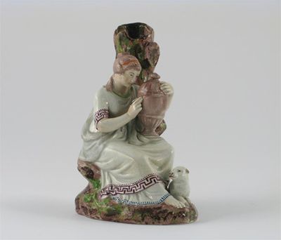 Appraisal: A pearlware spill vase modelled probably as Andromache resting against