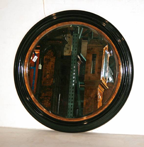 Appraisal: A Regency style parcel gilt ebonized mirror th century diameter