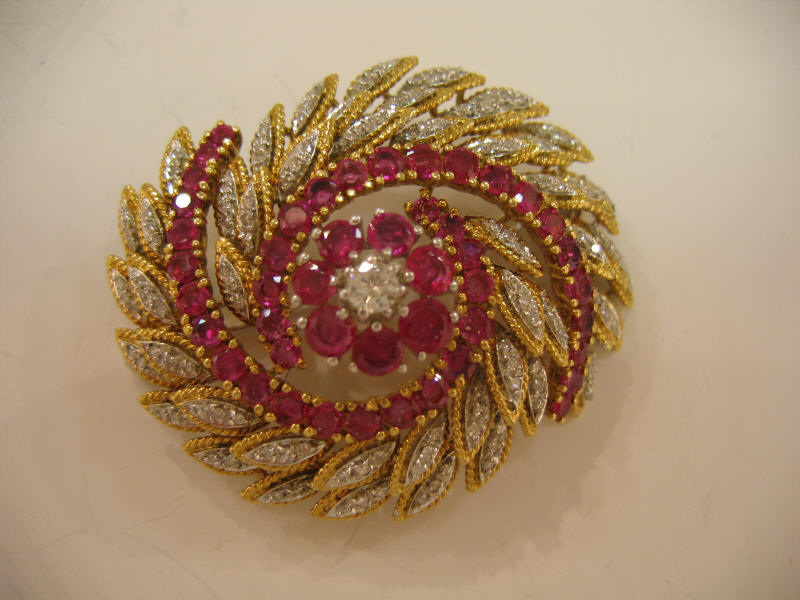 Appraisal: RUBY AND DIAMOND BROOCH k yellow and white gold swirl