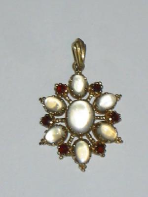 Appraisal: A MOONSTONE AND GARNET PENDANT the central oval cabochon moonstone