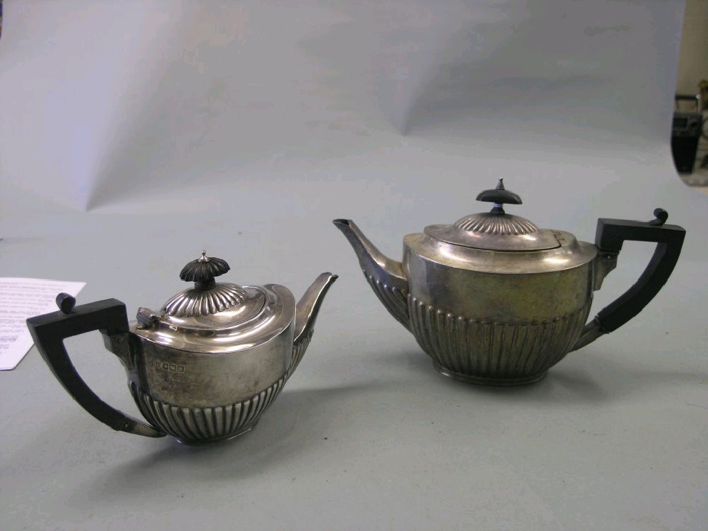 Appraisal: Two silver teapots oval half-reeded form Sheffield and