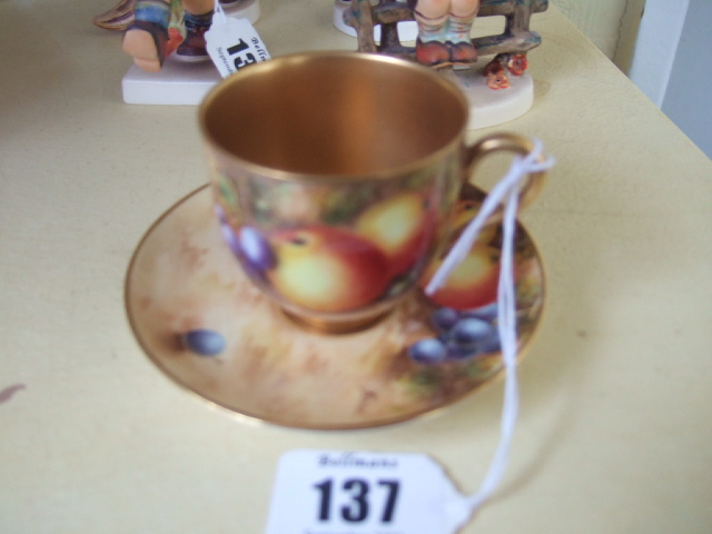 Appraisal: A Royal Worcester cabinet cup and saucer hand painted with