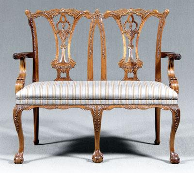 Appraisal: Chippendale style settee double chair back elaborately carved back rolled