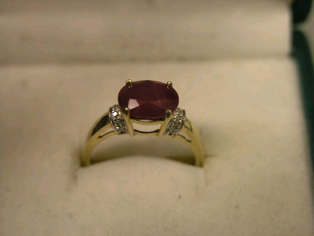 Appraisal: A ct gold ruby and diamond ring central faceted ruby