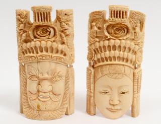 Appraisal: PAIR OF CARVED IVORY MASKS Chinese Of an emperor and