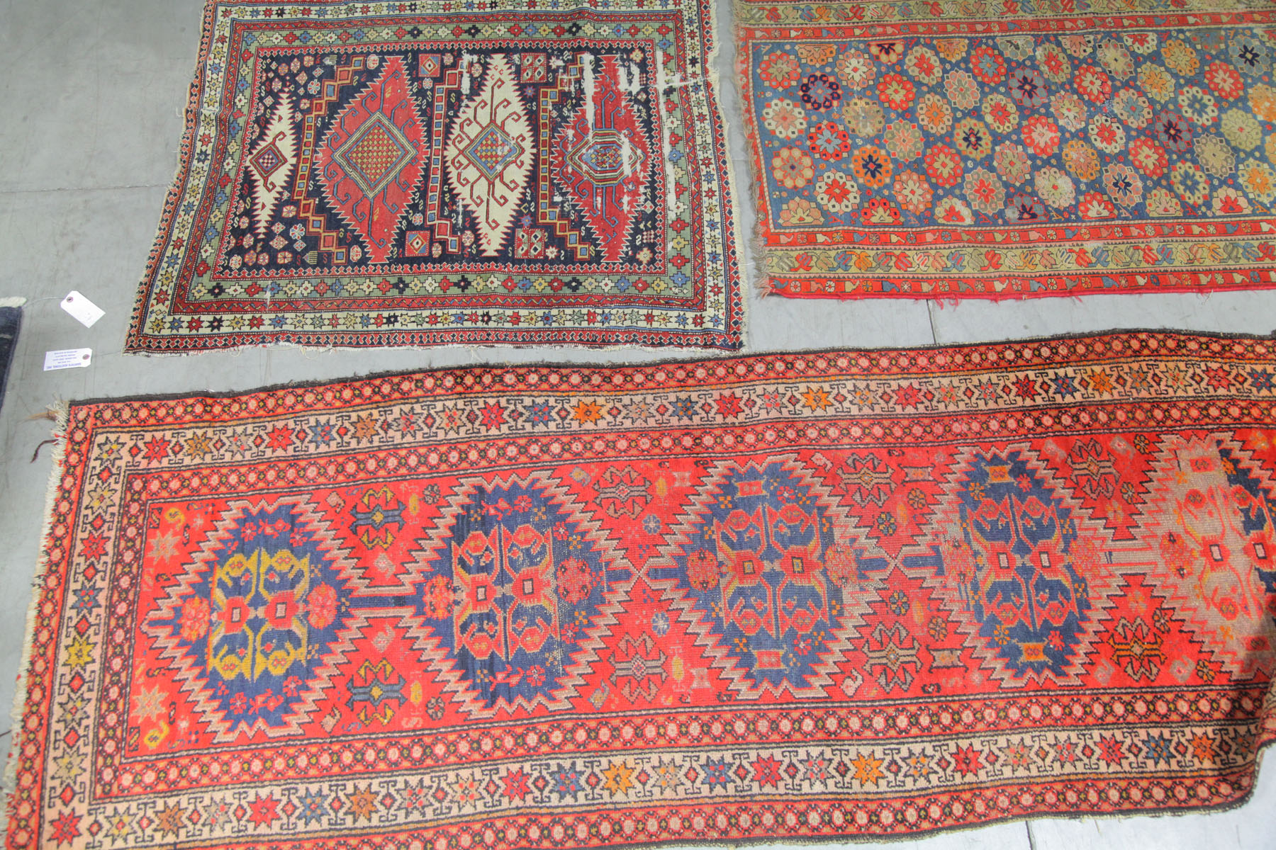 Appraisal: THREE ORIENTAL STYLE RUGS Asian th century Runner with red