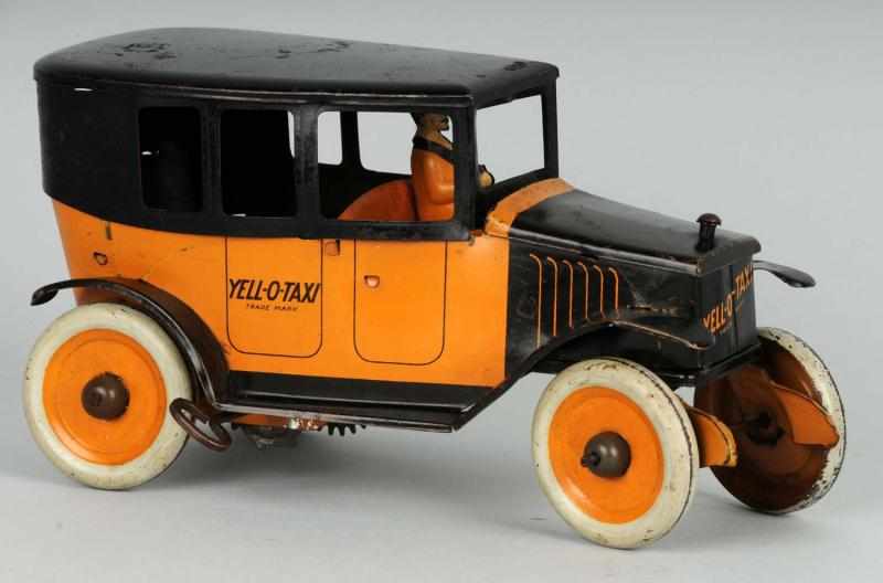 Appraisal: Tin Strauss Yellow Taxi Wind-Up Toy Description American Working Lithographed