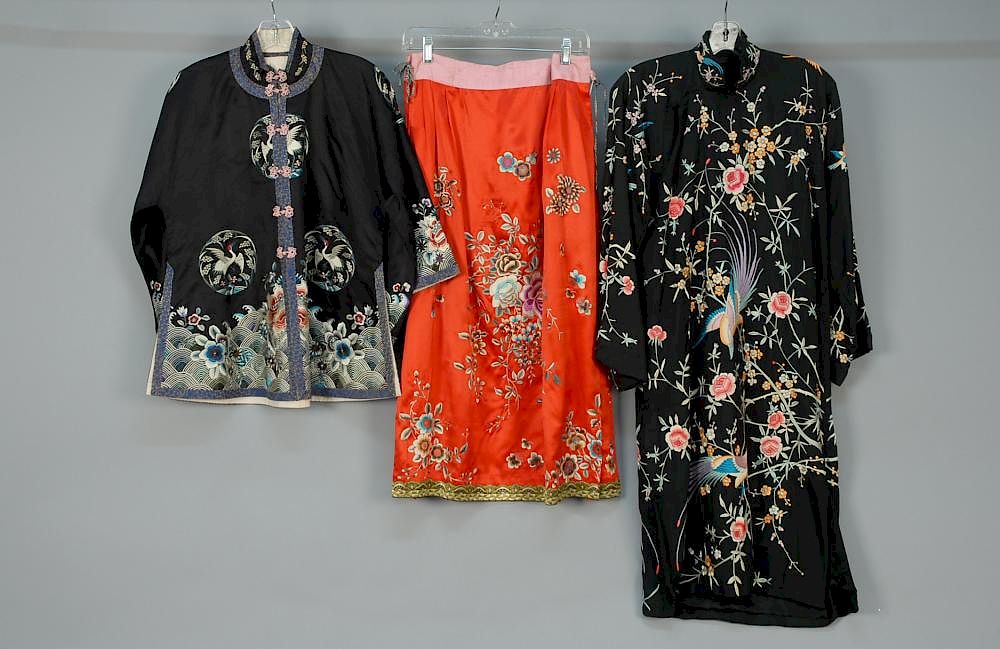 Appraisal: THREE CHINESE EXPORT EMBROIDERED SILK GARMENTS th C Black satin