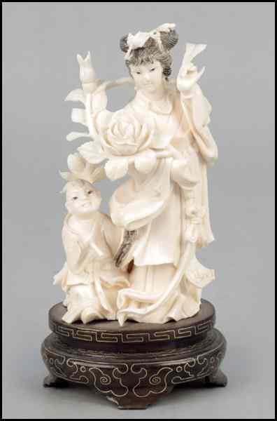 Appraisal: CARVED IVORY OF A MOTHER AND CHILD Raised on a