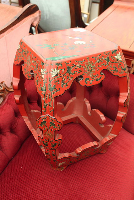 Appraisal: AN ORIENTAL RED LACQUERED STOOL with shaped legs beneath a