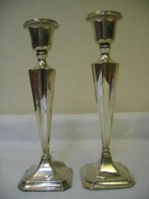 Appraisal: A PAIR OF CANDLESTICKS the urn shaped socket on square