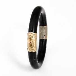 Appraisal: A ct gold snap joint polished dark green stone bangle