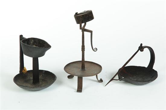 Appraisal: THREE WROUGHT-IRON LAMPS American or European mid th century Two