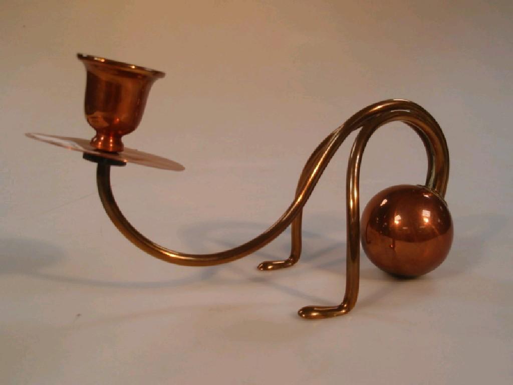 Appraisal: A brass and copper weighted candle stand in the manner