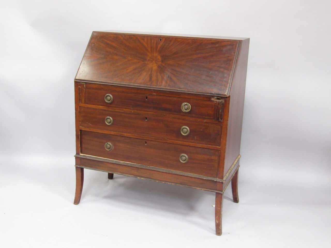 Appraisal: An Edwardian mahogany and cross banded bureau fall flap enclosing