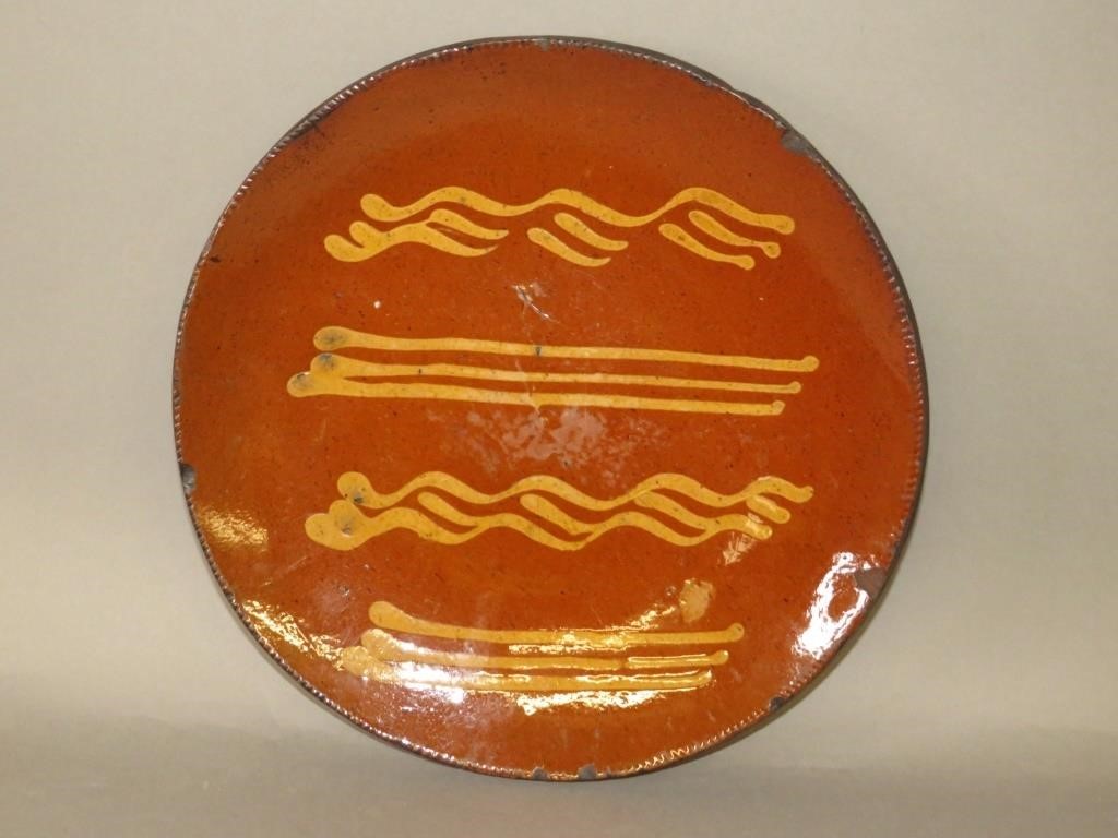 Appraisal: PA SLIPWARE PLATEca PA slipware drape molded plate with four