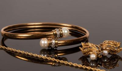 Appraisal: A k gold bangle with cultured pearl terminals and diamond