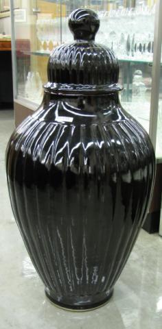 Appraisal: Modern ceramic lidded urn black with red tinted glaze inches