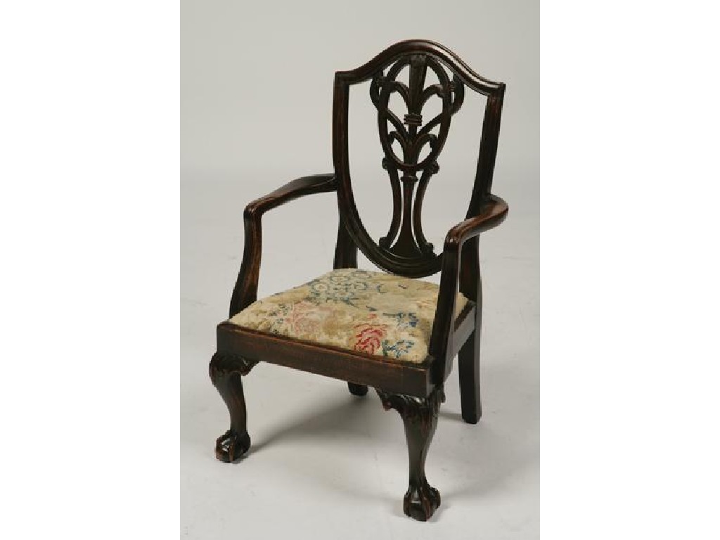 Appraisal: A CHILD'S MAHOGANY HEPPLEWHITE STYLE ARMCHAIR the shield-shaped back with